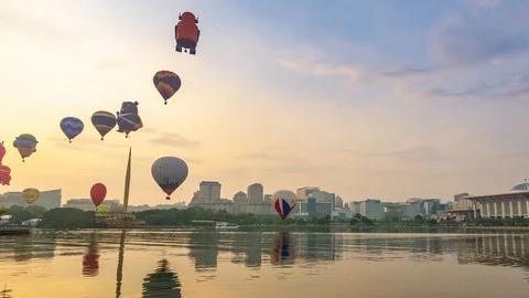 4K Time lapse of moving hot balloons over lake Putrajaya, Malaysia. Zoom In. Stock Footage 105442435