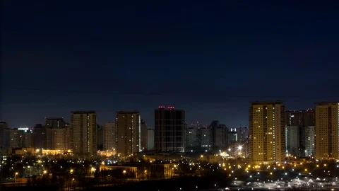 4K time lapse of night to day transition with city lights and colorful clouds Stock Footage 122174337