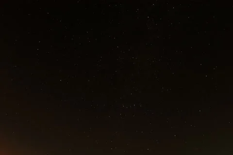 4K. Time lapse of the night sky with clouds and stars passing by behind a forest Stock Footage 42006818