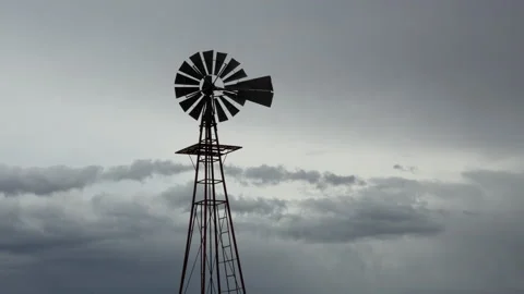 4K time lapse of an old windmill silhouetted by rain clouds in the American west Stock Footage 148972371