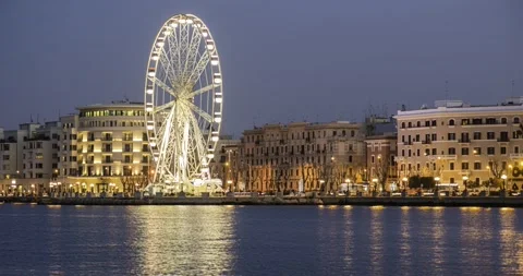 4K time lapse panoramic Night view of Illuminated giant Ferris wheel on the w 動画素材 171854260