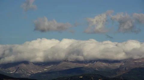 4K Time lapse of pileus cap clouds rolling over a Colorado Rocky mountain ridge Stock Footage 61345982