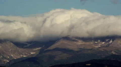 4K Time lapse of Pileus cap clouds rolling over a Colorado Rocky Mountain ridge Stock Footage 61346108
