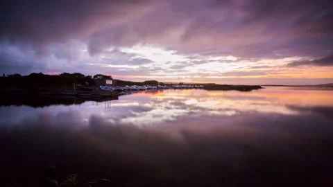 4k Time Lapse Reflections of Storm Clouds after Sunset Over the Harray Loch  Video stock 256099359