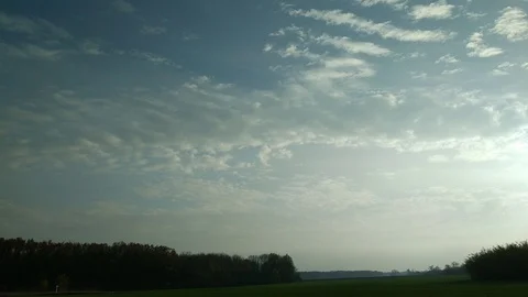 4K time lapse with running clouds with reflection in water and deep blue sky Stock Footage 97797299