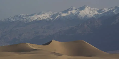 4K Time lapse of Sand Dunes and cloud shadows on snowy mountains in Death Valley Stock Footage 137670099