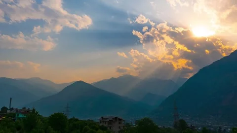 4K Time-lapse shot of sunrays in front of Himalayan mountain peak during the sun Stock Footage 341557713