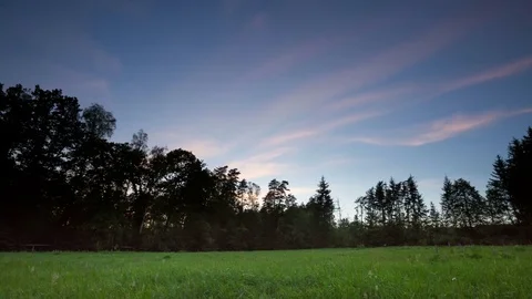 4k Time lapse of spectacular after sunset sky over summer meadow and forest. Stock Footage 79736305