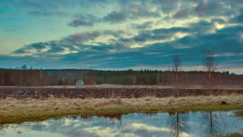 4k time lapse with spring landscape. Lonely house near forest under cloudy sky. Stock Footage 155594097