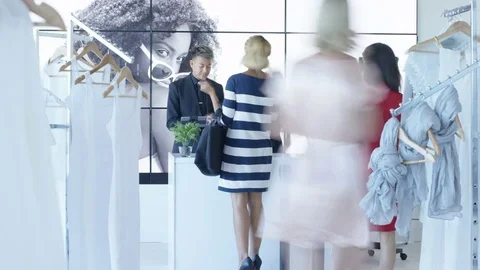 4K Time lapse staff serving customers in trendy clothing store Stock Footage 69884243