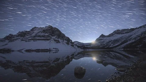 4K Time lapse of star trails moving over snowy mountain Stock Footage 84903973