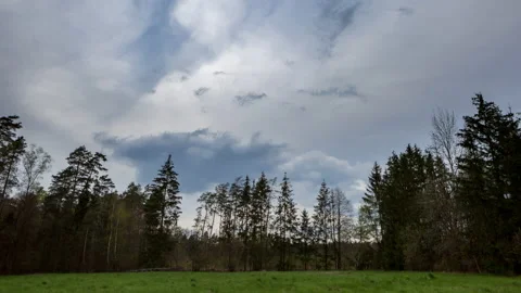 4k Time-lapse with stormy sky over meadow and forest Stock Footage 153572047