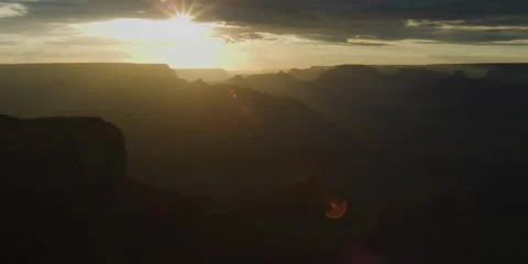 4K Time lapse of the sun dropping below clouds and illuminating the Grand Canyon Stock Footage 138117161