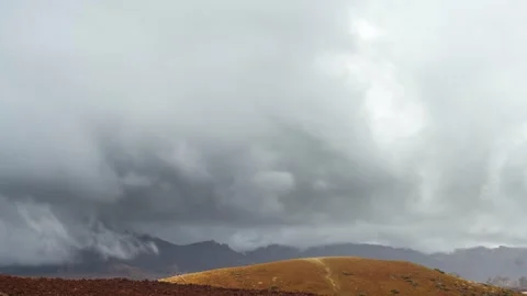 4K time-lapse of sunlit hill with dramatic rain clouds passing overhead Stock-Footage 332480514