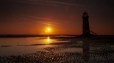 4k time lapse sunrise and lighthouse at Talacre, North Wales coast Stock Footage