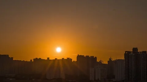 4K Time-lapse of Sunrise Glow with Silhouettes of Urban High-rises Stock Footage 341790700