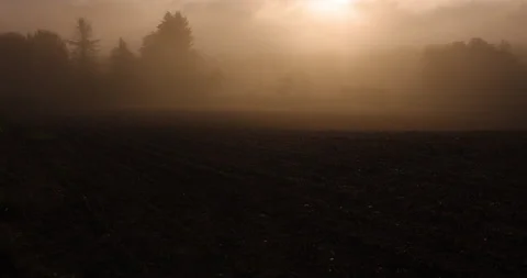 4k time lapse with sunrise over a plowed field. 스톡 동영상 208453042