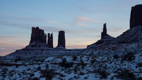 4K Time lapse of sunset clouds above snowy rock formations in Monument Valley Stock Footage 90808012