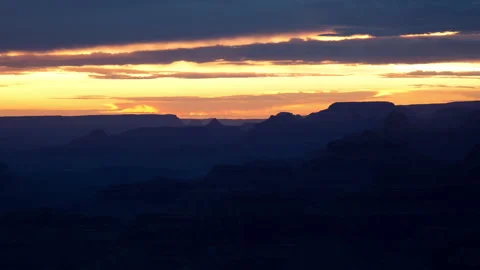 4K Time lapse of sunset clouds silhouetting canyon cliffs at the Grand Canyon Stock Footage 150004682