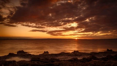 4K Time Lapse Sunset Lake Rocks Sea Weed Clouds Dolly Stock Footage 71382996