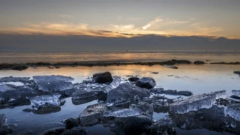4K Time Lapse Sunset Lake Ice Winter Beach Clouds Dolly Stock Footage 73497994