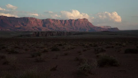 4K Time lapse of sunset light illuminating a red rocky desert ridge in Arizona Stock Footage 160286856