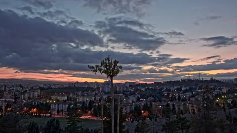 4K Time-Lapse of Sunset to Night Over City Skyline with Dramatic Clouds Stock Footage 321030957