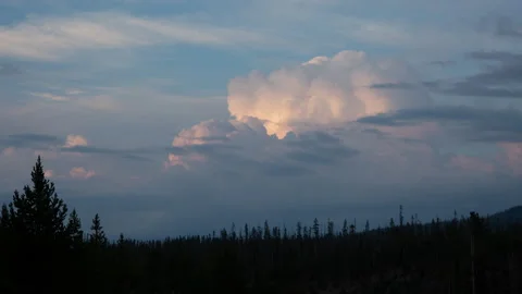 4K time lapse of a sunset thunderstorm over pines in Yellowstone National Park 스톡 동영상 215866326