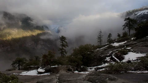 4K Time lapse of swirling clouds and sun rays in snowy Yosemite National Park Stock Footage 148302896