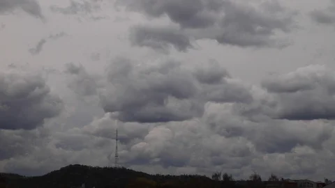 4K time lapse: television tower and beautiful fluffy clouds floating near. Stock Footage 129636163
