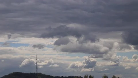 4K time lapse: television tower and beautiful fluffy clouds floating near. Stock Footage 136823000