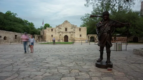 4K time lapse of tourists visiting the David Crockett sculpture at the Alamo Stock Footage 194080842