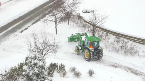 4K time lapse of tractor plowing snow near busy road Stock Footage 47007748