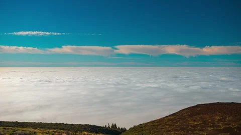 4K time-lapse of vast sea of clouds slowly flowing under blue sky Stock Footage 332932397