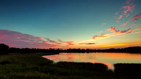 4k time lapse with vibrant after sunset sky over calm lake. Stock Footage 154498337