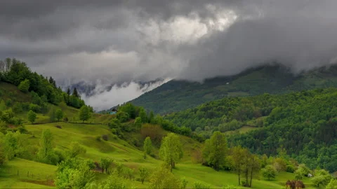 4k time lapse video of rolling clouds over rural landscape Stock Footage 130552225