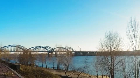 4K Time Lapse view of smoking pipes on the river bank with a large bridge. Thick Stock Footage 104013679