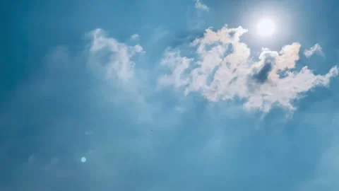 4K Time-Lapse of White Clouds Moving Across Blue Sky with Sunlight Stock Footage 342336082