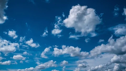 4K time lapse white fluffy clouds move fact over blue sky Stock Footage 90224895
