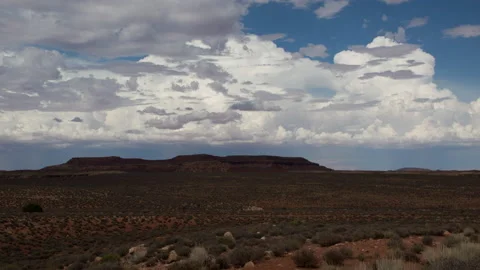 4K Time lapse wide shot of cumulus clouds forming in blue sky above desert mesas Stock Footage 158443389