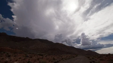 4K Time lapse wide shot of clouds forming in blue sky above desert mountains Stock Footage 158458065