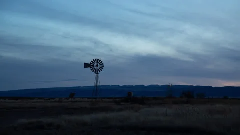 4K Time lapse wide shot of a traditional windmill in west Texas at dusk Stock Footage 166537960