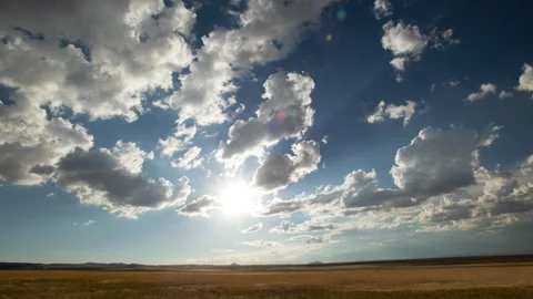 4K Time lapse wide shot of the sun and clouds in a blue sky over Utah Prairie Stock Footage 213345531