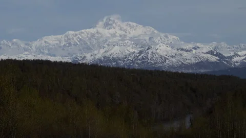 4K time lapse of wispy spring clouds swirling on a snowy Mount Denali in Alaska Stock Footage 242727630