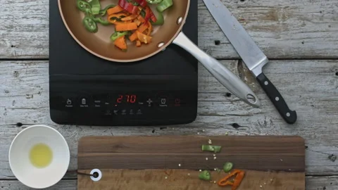 4k Time lapse of woman's hands preparing, cutting and fraying peppers on digital Stock Footage 199615999