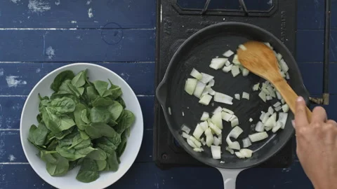 4k Time lapse of woman's hands preparing and cooking baby spinach leaves with on Stock Footage 199616014