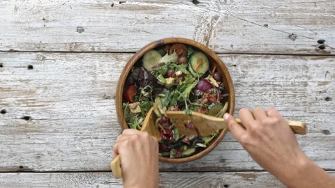 4k Time lapse of woman's hands tossing the a salad. Stock Footage 199616354