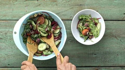 4k Time lapse of woman's hands tossing, and dishing salad,  ready to eat. Stock Footage 199616358