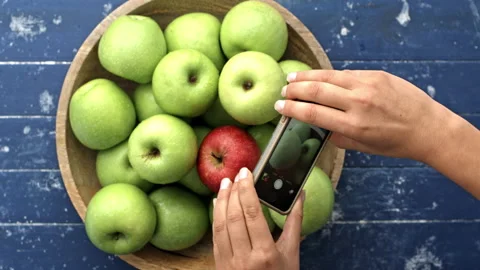 4k Time lapse of Woman's hands taking picture of apples in wooden bowl with smar Stock Footage 199616566