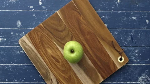 4k Time lapse of woman's hands eating green apple on placing it on cutting board Stock Footage 199616570